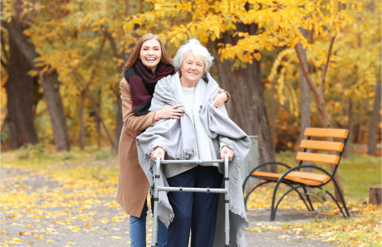 woman and senior woman walking in a park