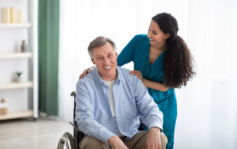 senior man in a wheelchair and his caregiver