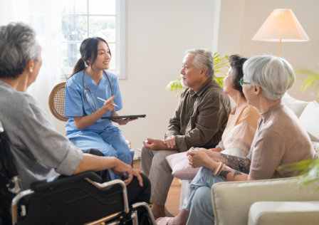 caregiver talking while the senior men and women are listening