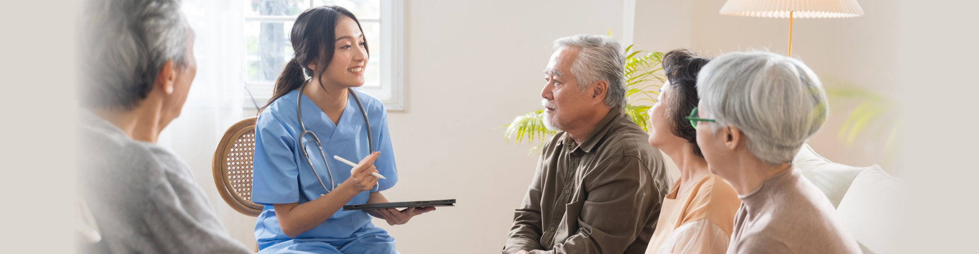 caregiver talking while the senior men and women are listening