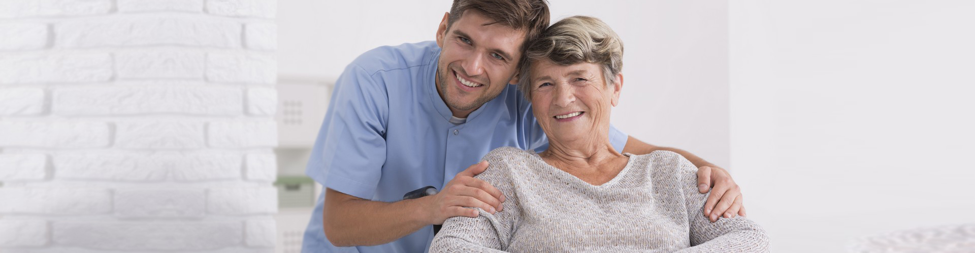 caregiver hugging senior woman